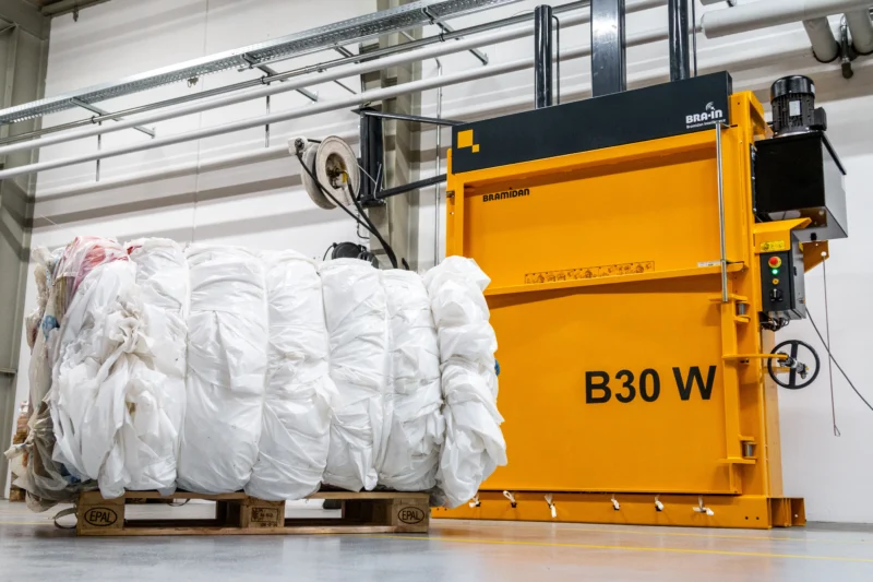 B30 Wide baler and plastic bale in front