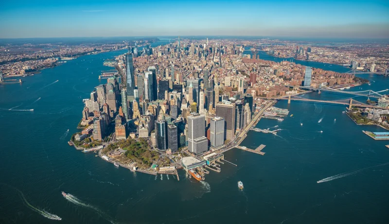 Aerial view of Lower Manhattan with skyscrapers, bridges, and the surrounding waterways