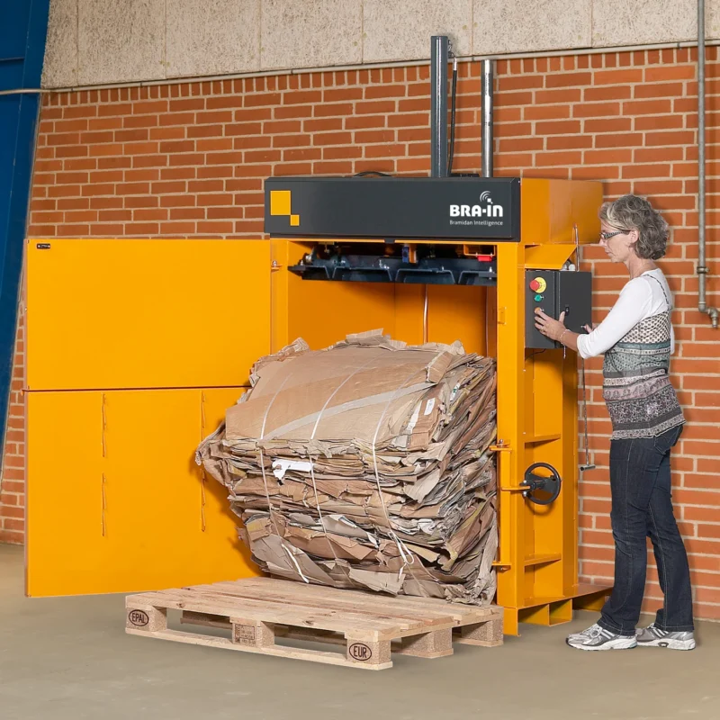 Woman ejecting a cardboard bale from a B5 Wide baler