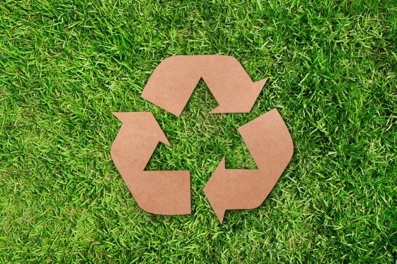 Recycle sign on grass
