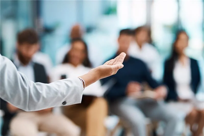 Sitting people receiving in-person operator training in a class